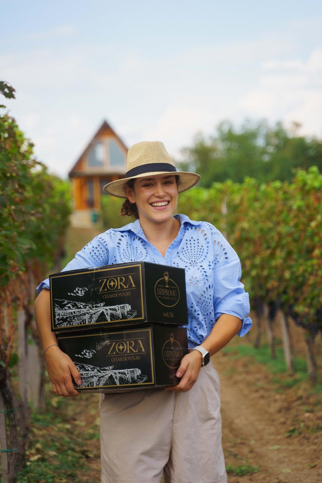 Anja Džipković in the vineyard with Zora wine boxes